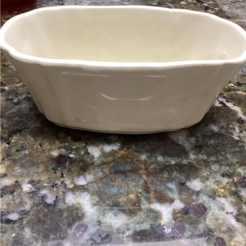 This small off-white ceramic dish is homemade by someone in the USA years ago.